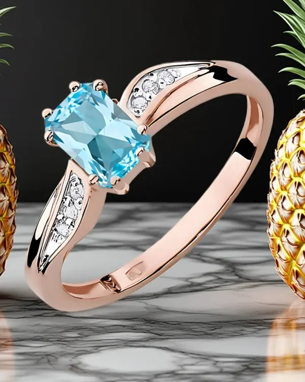 Pierścionek zaręczynowy z różowego złota 585 z błękitnym topazem 0.65ct i diamentami, ręcznie wykonany przez BigDIAMOND Kraków.