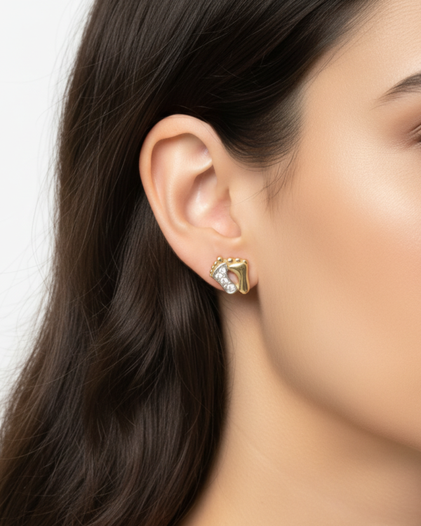 Model wearing gold earrings with zirconia.